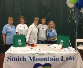 From left, Pam Alford, Lori Smith, Vicki Gardner, Andie Gibson and Paula Shoffner, members of the Take Pride in Smith Mountain Lake oversight committee, prepare to register volunteers at the 2018 SML Business Expo at the YMCA at LakeWatch Plantation. More than 50 people signed up at the Expo, receiving a free T-shirt, work gloves, heavy duty orange trash bags, a grocery tote and a ticket to a celebratory dinner at Mango’s Bar & Grill.